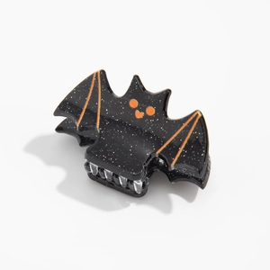 Détail de la pince à cheveux chauve-souris pailletée noire et orange pour Halloween