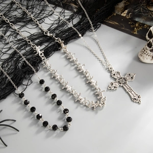 Detail of gothic punk beaded necklaces with cross pendant and star zircon accents