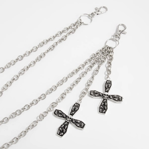 Detail of triple-layer silver hip-hop chain featuring skull embossed cross pendants