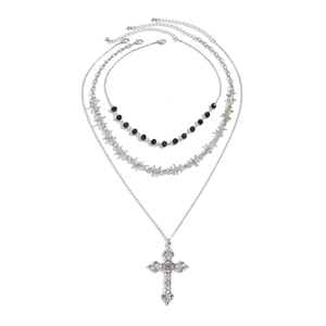 Detailed close-up of triple-layered punk necklace with cross pendant and barbed wire links