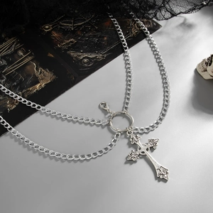 Gothic silver metal cross pendant body chain with ornate baroque patterns on black lace background