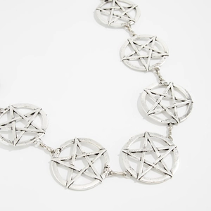 Close-up of vintage silver pentagram metal chain with antique finish and geometric links