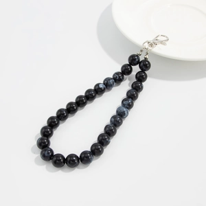 Detail of marble pattern beads and silver lobster clasp for mobile chain and key strap