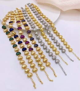 Détail de bracelets cœur avec cristaux colorés et fermoir mousqueton plaqué or 18 carats