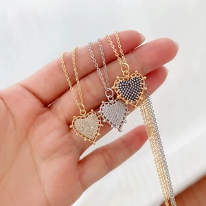 Three elegant 18K gold and silver heart pendants with cubic zirconia on fine O-chains