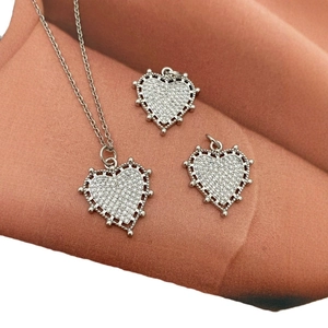 18K silver plated heart pendant necklace set with pavé cubic zirconia on textured fabric