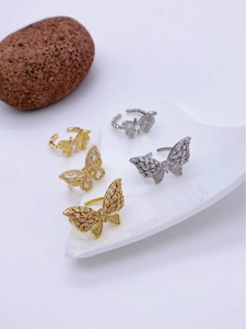 Detail shot of five butterfly zircon rings with 18k gold plating on artistic stones