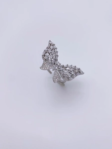 Detailed close-up of butterfly ring featuring marquise and round cubic zirconia stones