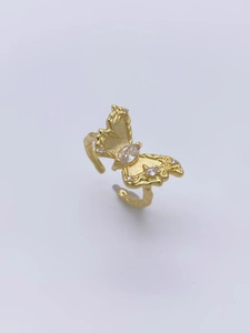 Detailed macro view of S925 stamped band and hammer-textured gold butterfly ring