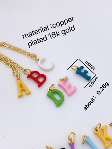 Detail of colorful 18k gold plated letter charms showing size 12mm x 6.5mm with chains