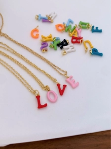 Macro shot of colorful enamel 18K gold plated letter charms arranged to spell LOVE