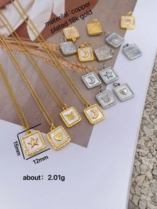 Macro detail of 18K gold plated copper square pendant with mother of pearl shell inlay