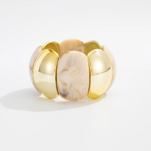 Macro detail of elastic resin bracelet with gold-tone metal and marbled oval beads