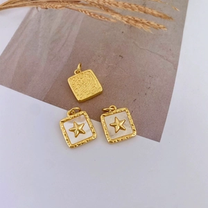 French vintage gold plated shell pendants with star motifs and textured metal charms