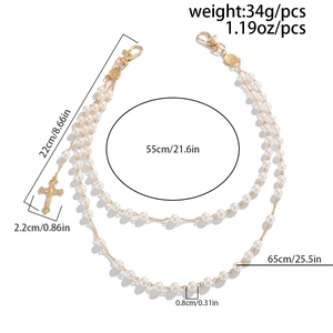 Detail showing multi-layer pearl waist chain with cross pendant and metal lobster clasp