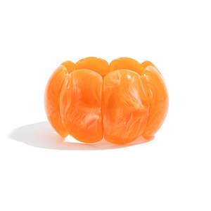 Detail of orange resin elastic bracelet with white marble texture and glossy finish
