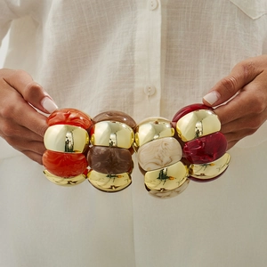 Detail view of bohemian elastic bracelets with gold metal and marble resin textures