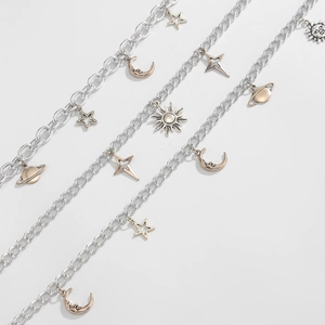 Detailed macro view of punk star and moon charms on silver trousers chain links