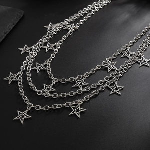 Punk style multilayer silver chain belt with hollow star pendants on black background
