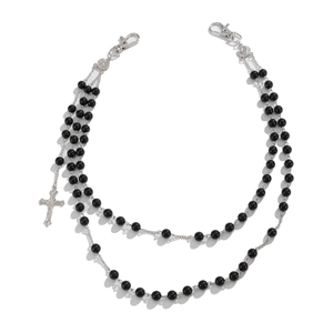 Detail of double-layer punk waist chain with black beads and a cross pendant charm