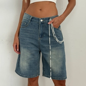 Detail showing multi-layer pearl chain decor on blue washed denim shorts pocket