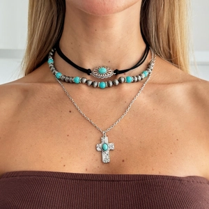 Bohemian layered necklace set with turquoise beads, velvet choker, and silver cross pendant