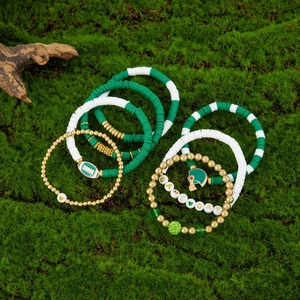Detail of Game Day football bracelet set with green clay beads on moss background