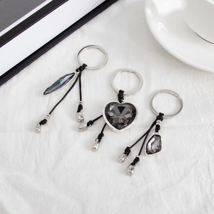 Three-piece keychain set featuring heart and geometric grey acrylic crystals in silver frames