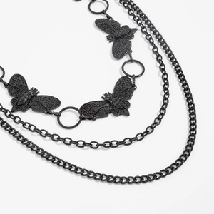 Detail of gothic black multi-layer chain belt with hollowed-out butterfly pendants