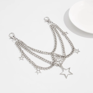 Macro shot of multi-layered silver metal bag chain with star pendants and lobster clasps