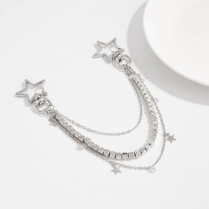 Detail of silver multi-layer metal chain with star charms and punk style key hooks