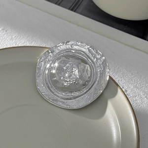 Détail macro d'une broche en métal plissée irrégulière avec texture martelée argentée