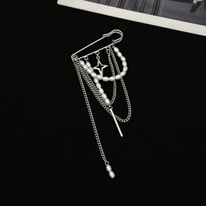 Silver chain brooch with imitation pearls and star pendant on a large safety pin