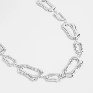 Close-up of irregular hollow geometric link chain with polished silver mirror finish