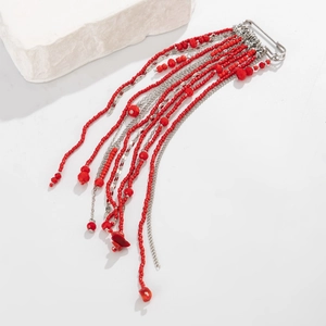 Detailed macro view of crystal beads and silver tassels on a luxury suit brooch pin