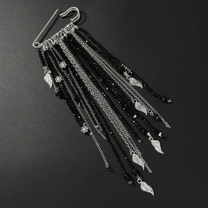Macro view of multi-layer black bead tassels with silver feather and flower charms