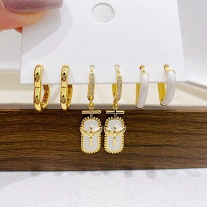 Three-piece set of gold-plated hoop earrings with hearts and zircon angel pendants