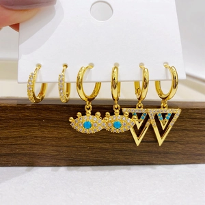 Detailed set of gold plated earrings featuring cubic zirconia and evil eye charms