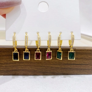 Close-up of gold-plated hoop earrings with vibrant rectangular cubic zirconia pendants