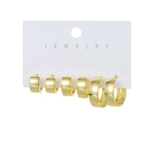 Close-up of three pairs of gold-plated hoop earrings with micro-set zircon details