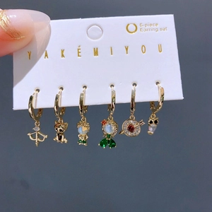 Nahaufnahme von 6-teiligem goldenem Ohrring-Set mit bunten Zirkon-Anhängern auf Karte