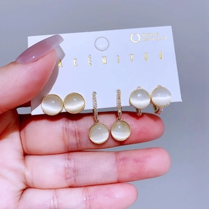 Elegant gold-plated opal earring set with three pairs of sparkling studs and hoops