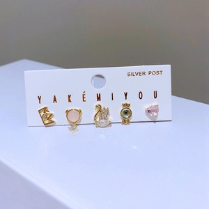 Detail of 5-piece earring set featuring swan, heart, and candy shapes with silver posts