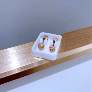 Macro shot of 5mm double-headed barbell earrings with champagne crystal pavé inlay