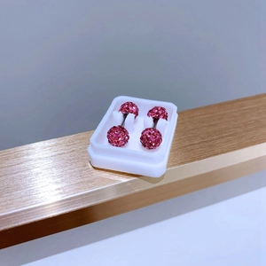 Detail view of 6mm pink crystal paved ball stud earrings with titanium screw backs