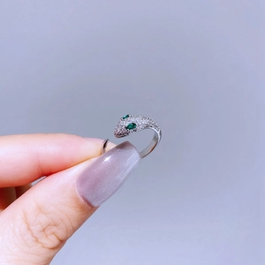 Silver snake ring with green emerald eyes and sparkling micro-pave cubic zirconia crystals
