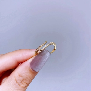 Detailed view of an elegant gold wrap ring featuring sparkling micro-pave cubic zirconia