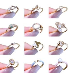 Set of 12 luxury gold rings with pearls, zircon stones, and colorful enamel patterns