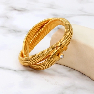 Macro detail of 18K gold plated tubogas bracelet featuring a sparkling zircon stone setting