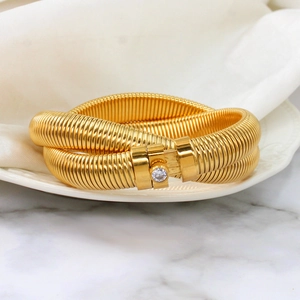 Detail of 18K gold snake chain bracelet featuring a sparkling zircon stone inlay